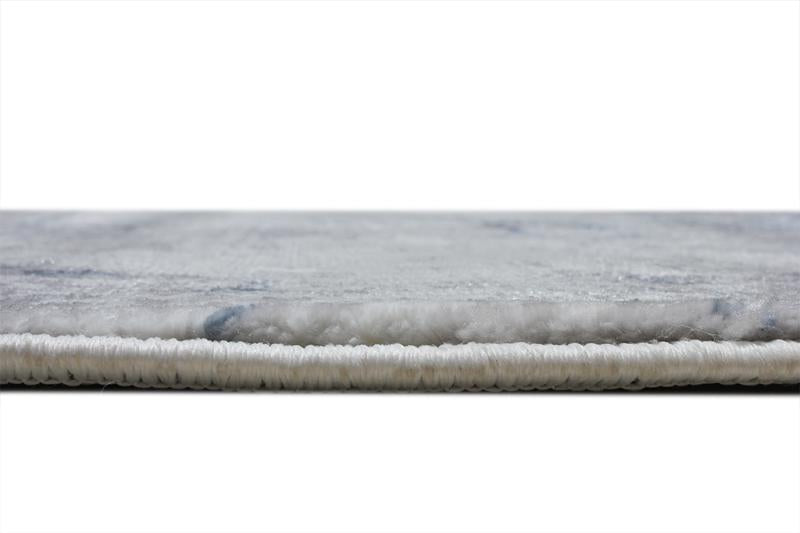 Angled view of Lizy Rug under a seating arrangement, illustrating its ability to enhance room aesthetics with vibrant color.