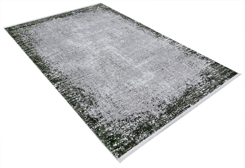 Overhead view of abstract gray and dark green area rug