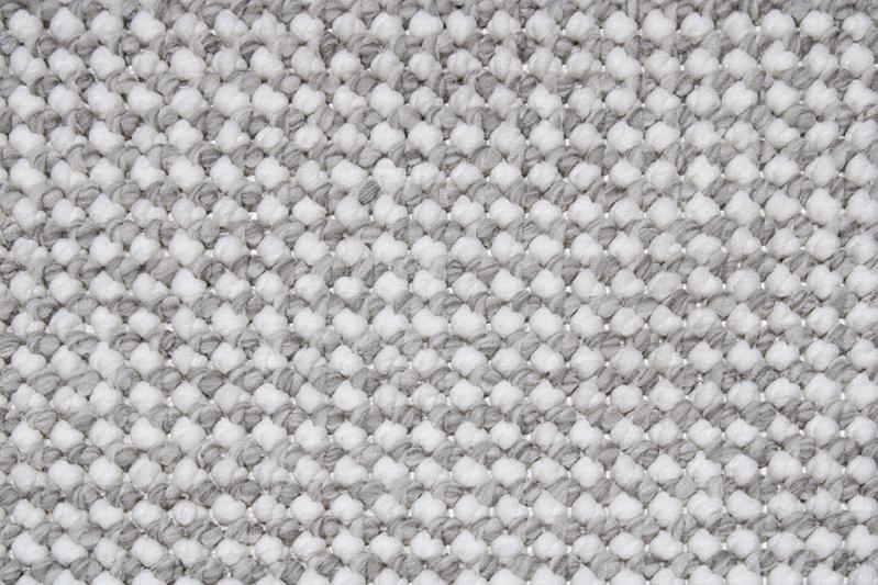 Angled view of Nairobi Rug under furniture, illustrating its adaptability and seamless fit into different room settings.