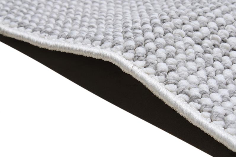 Close-up of the Nairobi Rug's fibers, emphasizing its soft texture and versatile gray shade that complements various styles.