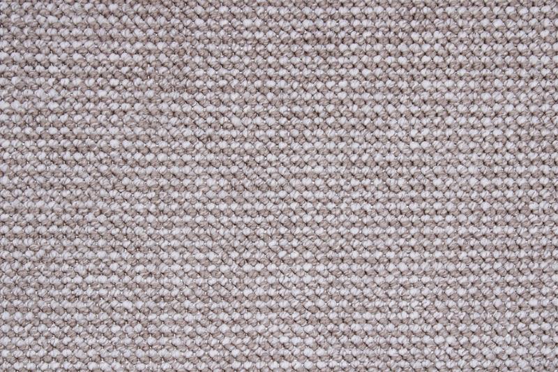 Close up view of woven fabric texture in beige and white.