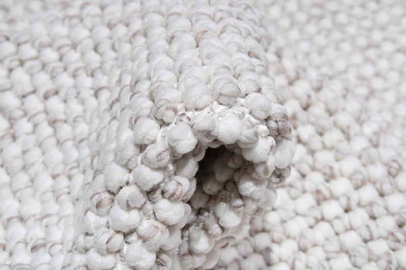 Close up rolled white and brown bobble rug texture