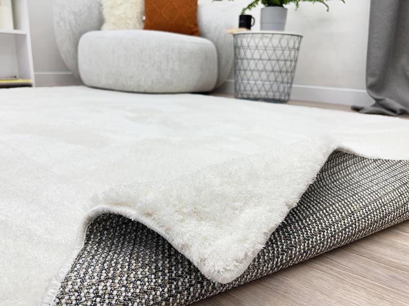 Angled view of Tampa Shaggy Rug under a coffee table, showcasing its seamless fit into cozy interiors.