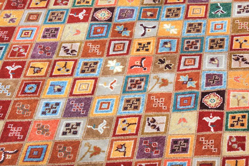 Close up view of colorful patterned area rug squares