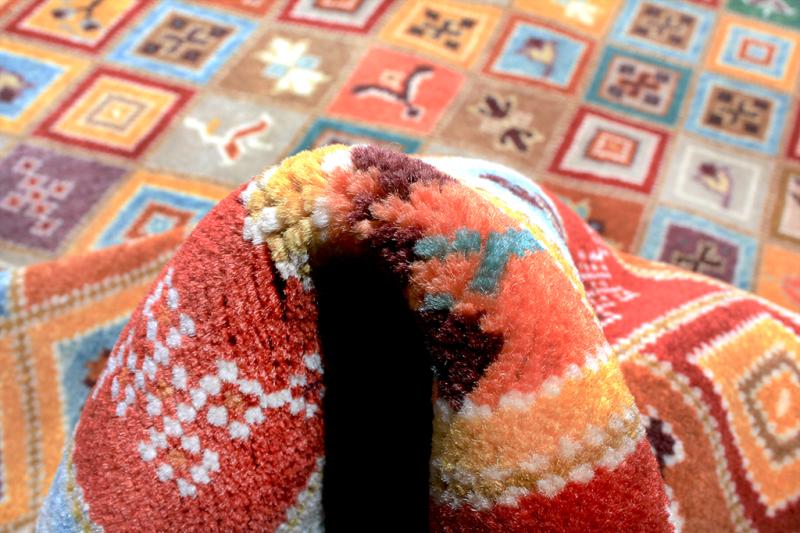 Close up view multicolored patterned rug rolled up showing texture