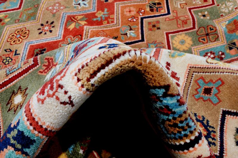 Close up view of colorful patterned rug folded over