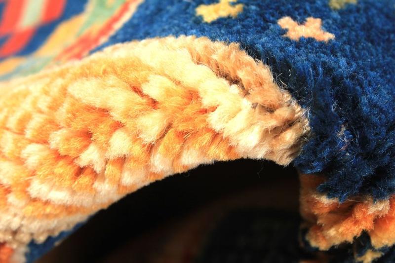 Close up of blue and orange woven rug edge