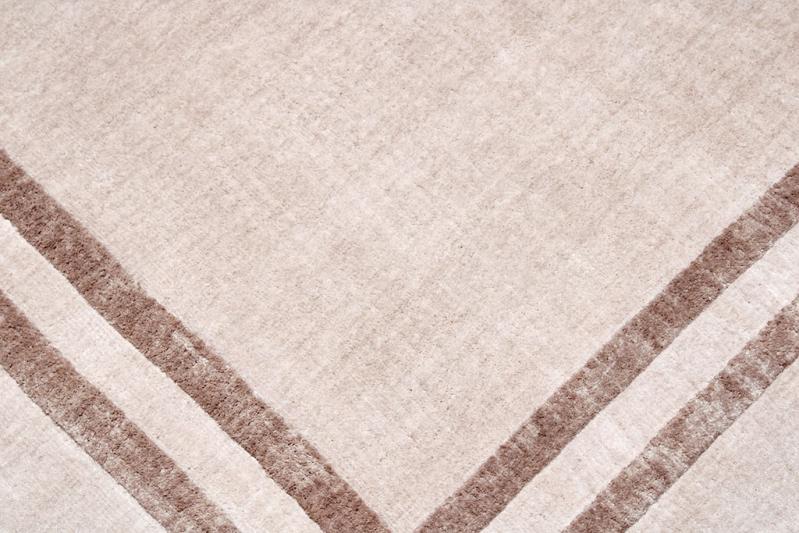 Cornelli Rug displayed in a contemporary living room, enhancing the space with its neutral tone and elegant design.