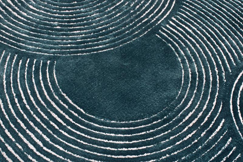 Close-up of the Trace Tufted Rug's textured pattern, showcasing its elegant design and soft feel.