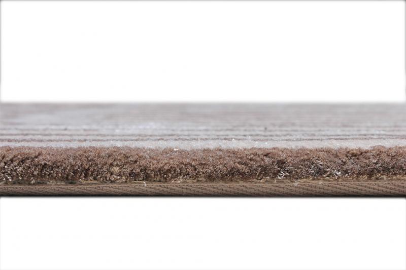 Close-up of the Luzione 906 Trace Tufted Rug, a modern striped area rug in brown and beige tones, perfect for adding warmth to any room