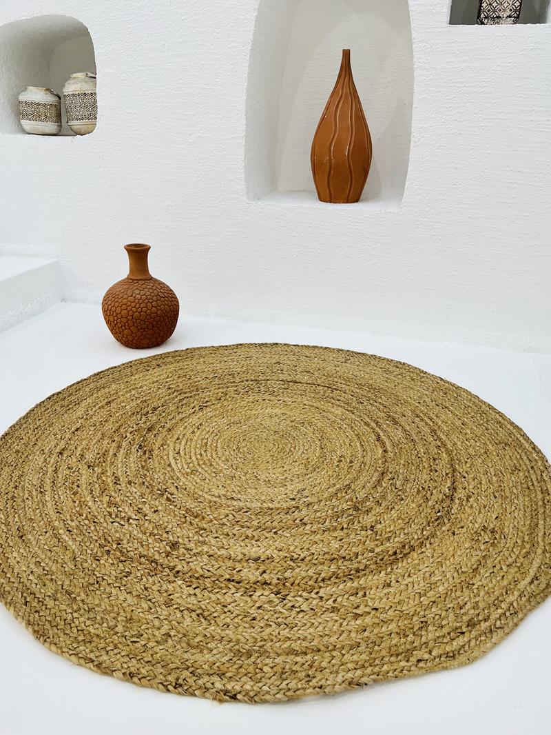 Round braided jute rug with terracotta vases in white niche decor