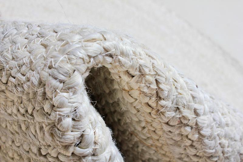 Detail of folded rug edge highlighting thickness and braided weave.
