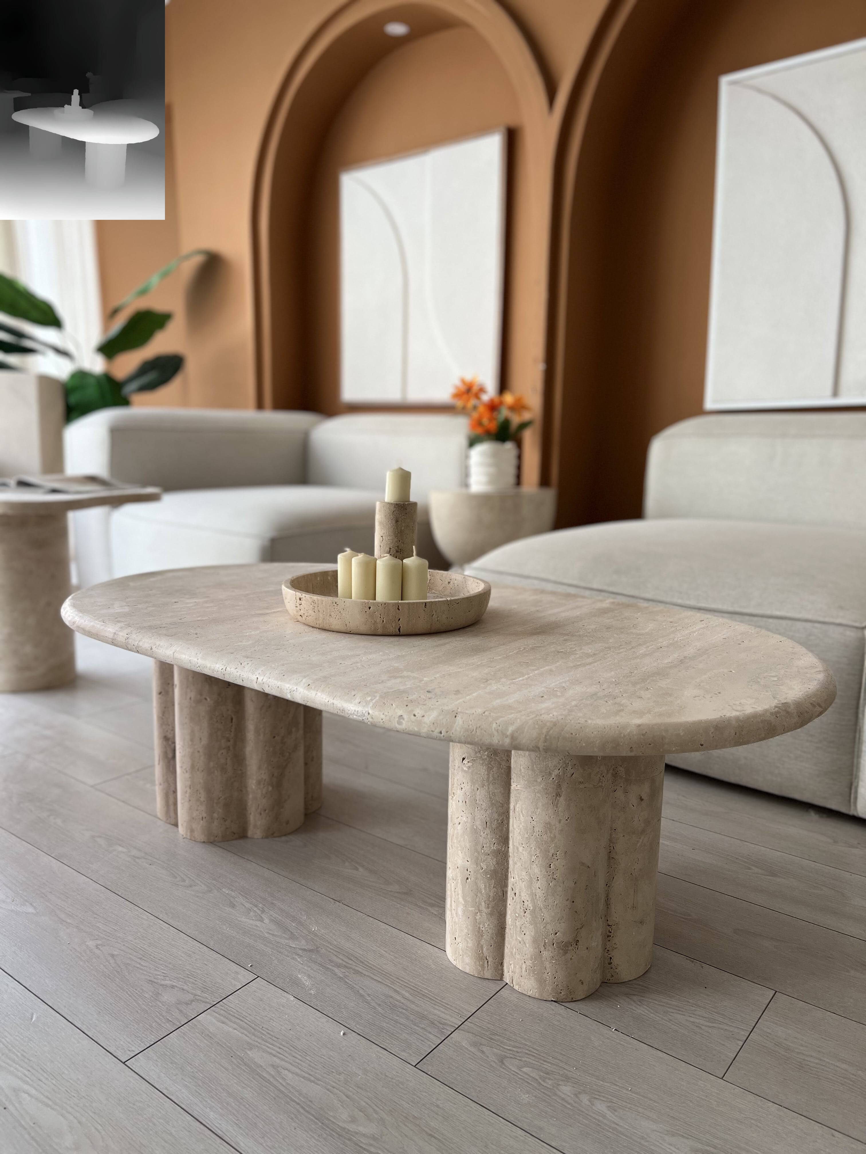 Modern living room featuring a Luzione Base Travertine Coffee Table with sculpted pedestal base and travertine accents. Natural elegance and modern sophistication.