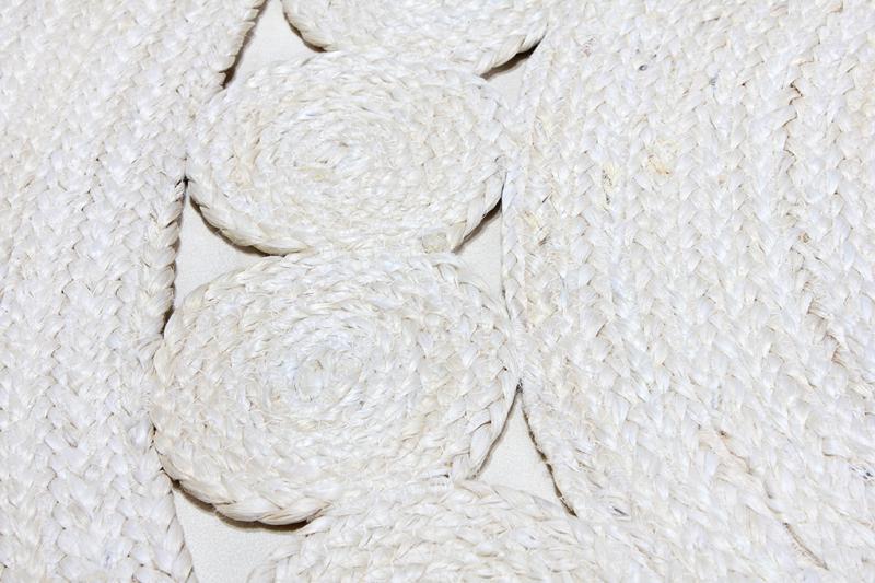 Close up view of white braided jute rug texture and pattern