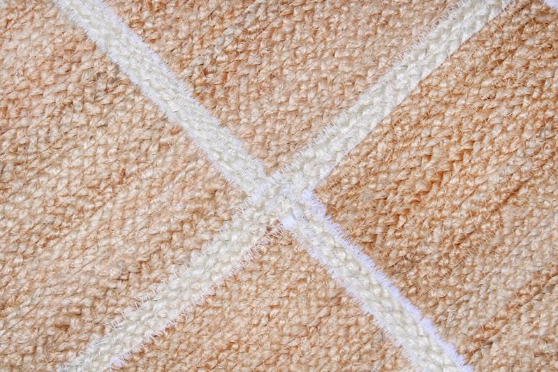 Close up woven jute rug with white stripe pattern
