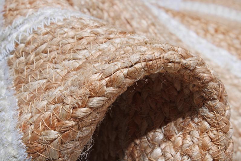 Close up of braided jute rug with white stripes