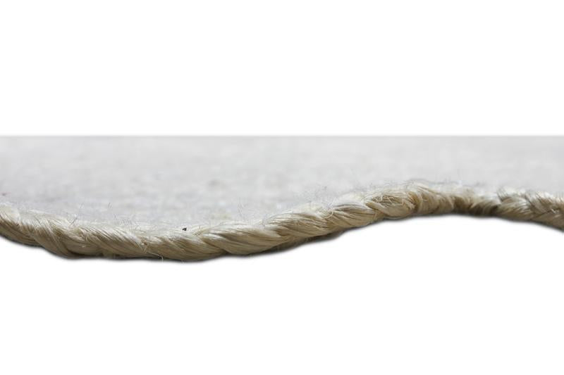 Close up view of white braided jute rug edge