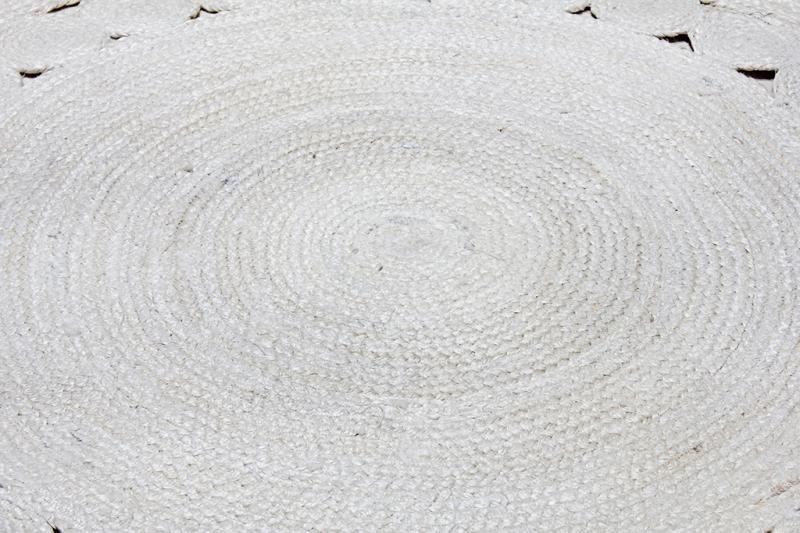 Close up white woven round jute rug texture