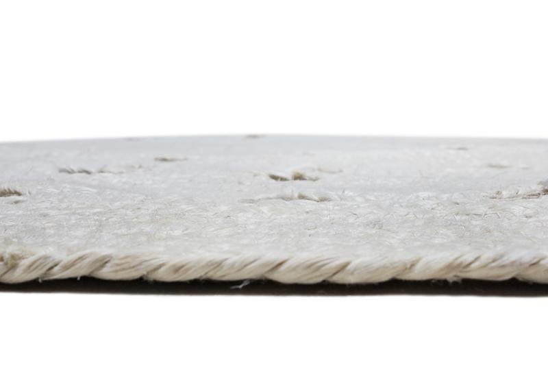 Close up view of white braided rug edge and texture