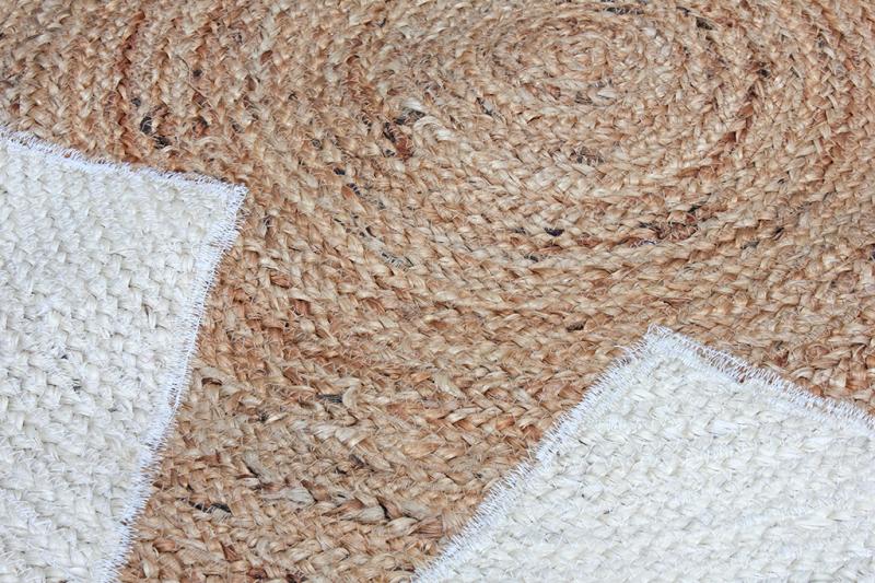 Close up of braided jute rug with white woven border