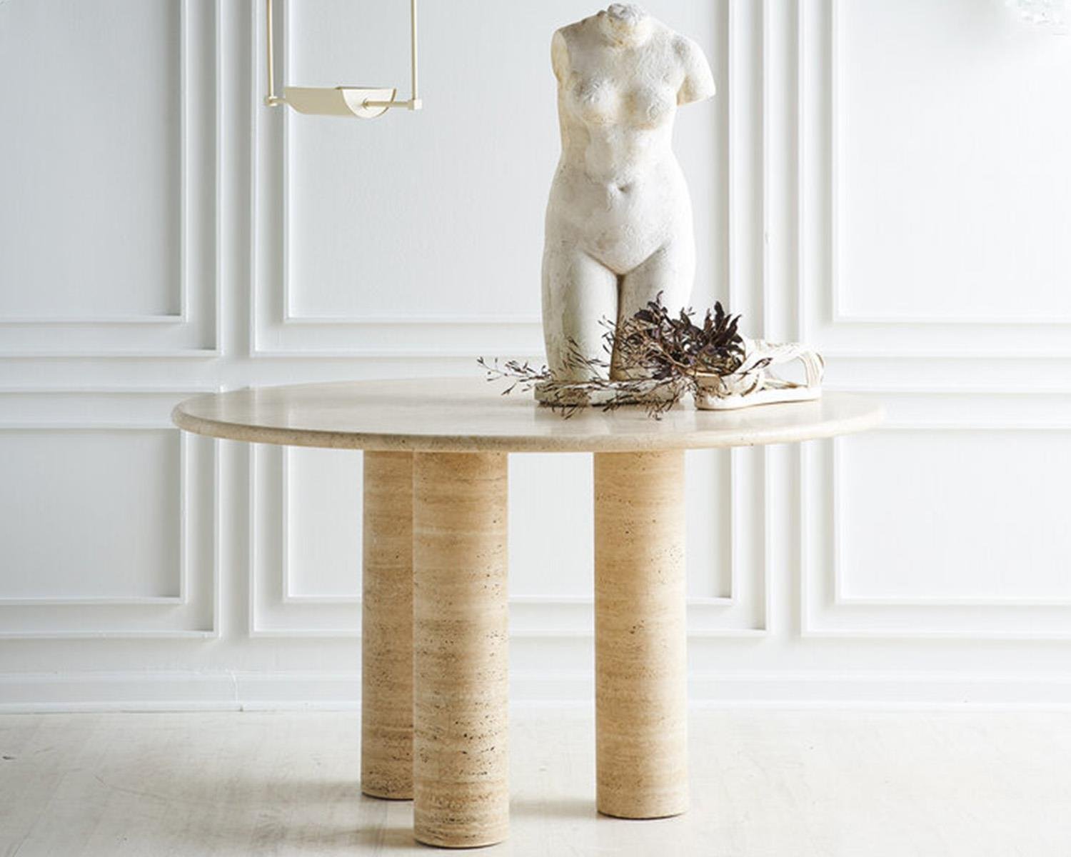 Travertine round table with three cylindrical legs, white torso sculpture
