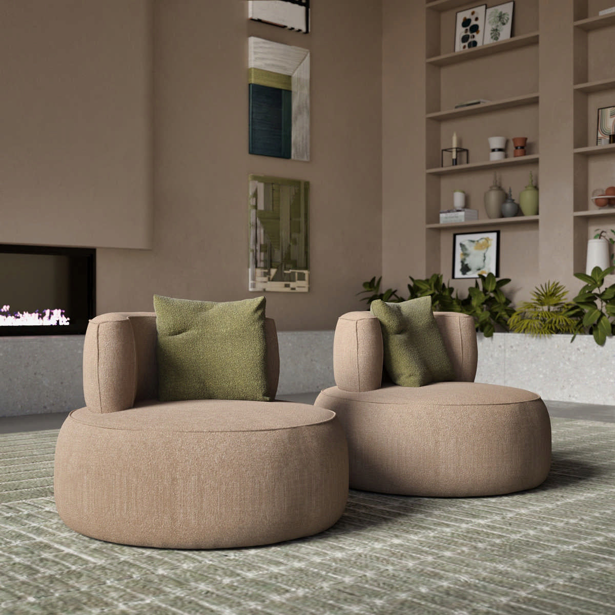 View of two round beige upholstered armchairs with green pillows on rug