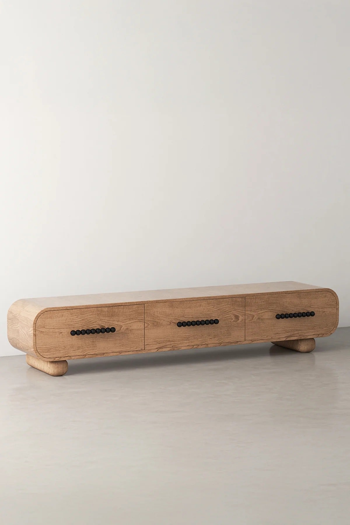 Wood media console with three drawers and black handles