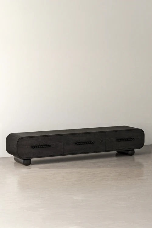 Black wood console cabinet with three drawers and rounded ends
