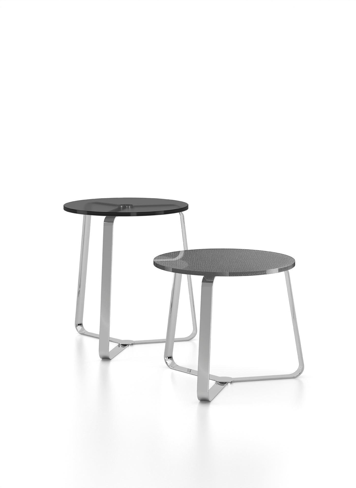 Two round nesting tables with chrome legs on white background