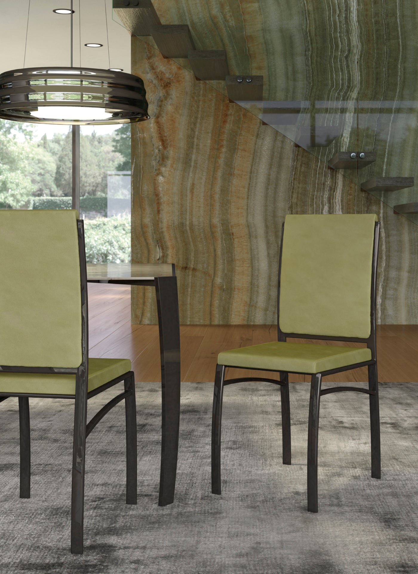 Dining chairs with green upholstery and dark metal frames on rug