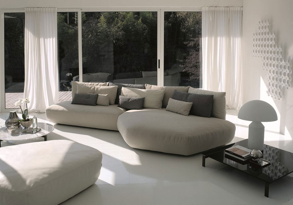 Curved modular sofa, ottoman, coffee table, and mushroom lamp.