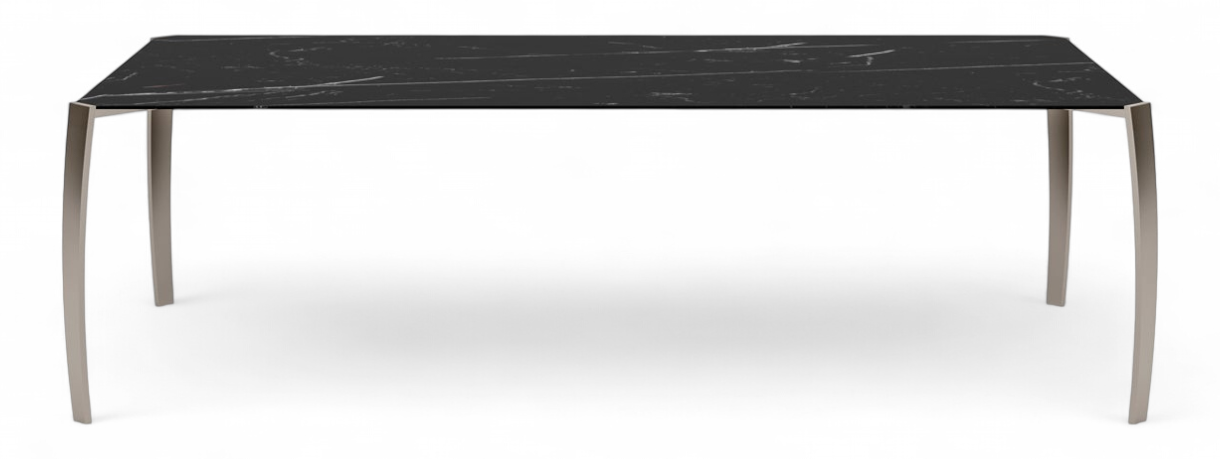 Spider Dining Table Studio shot of long black marble dining table with metal legs