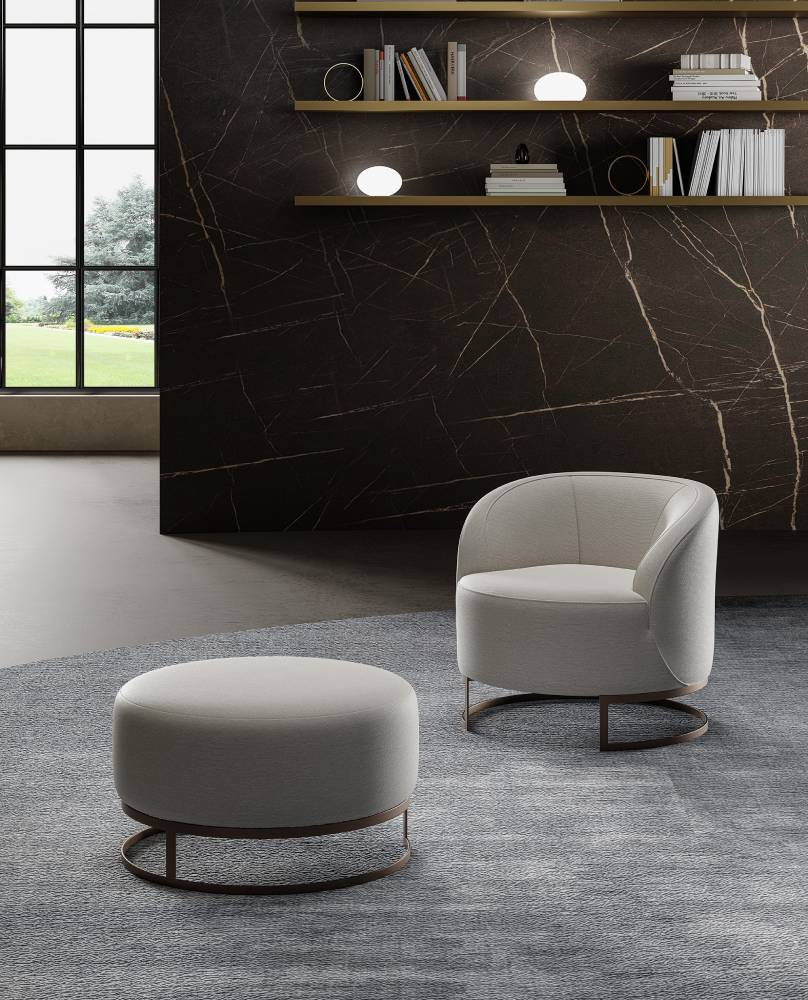 Modern armchair and ottoman set on blue rug