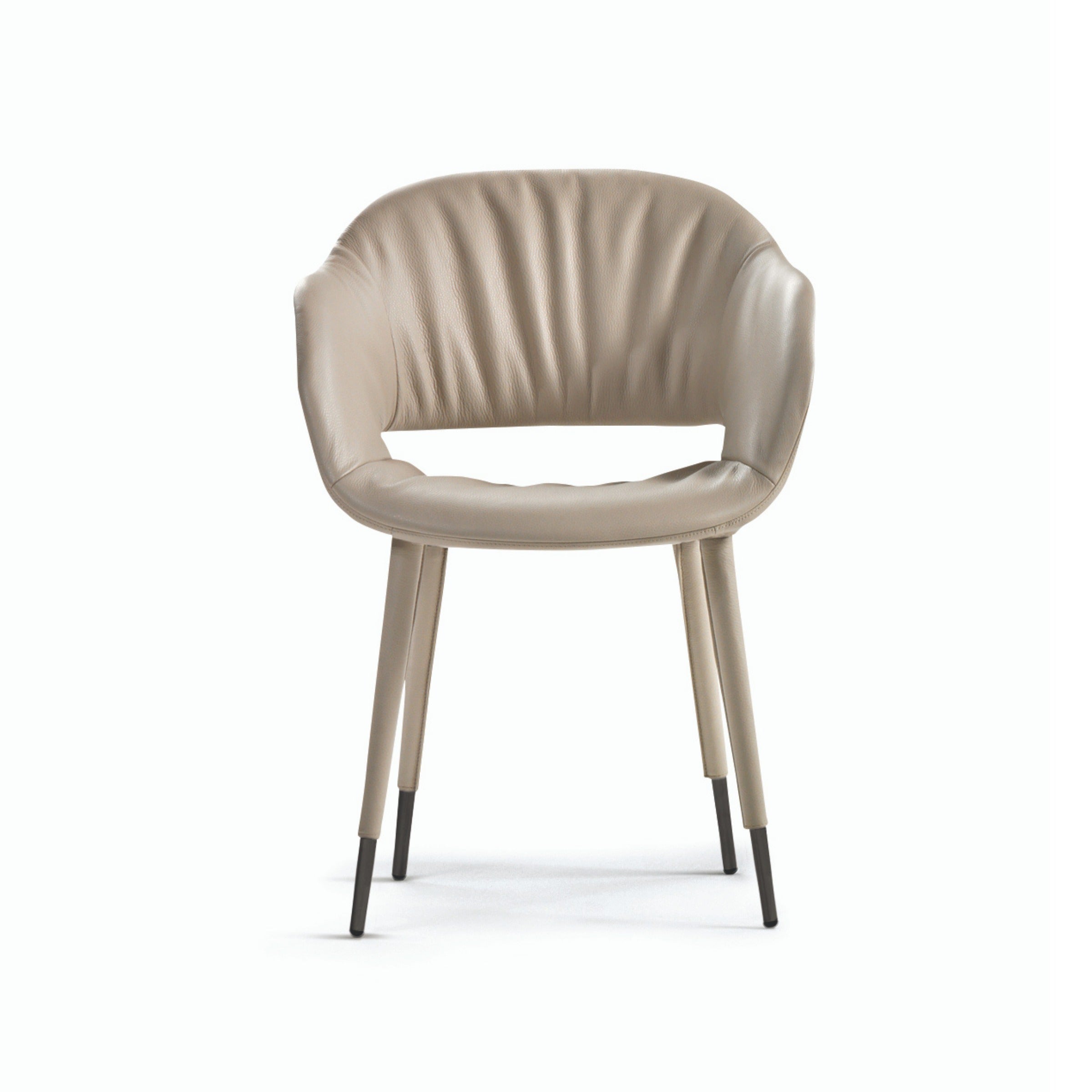 Studio shot of beige leather dining chair with metal legs