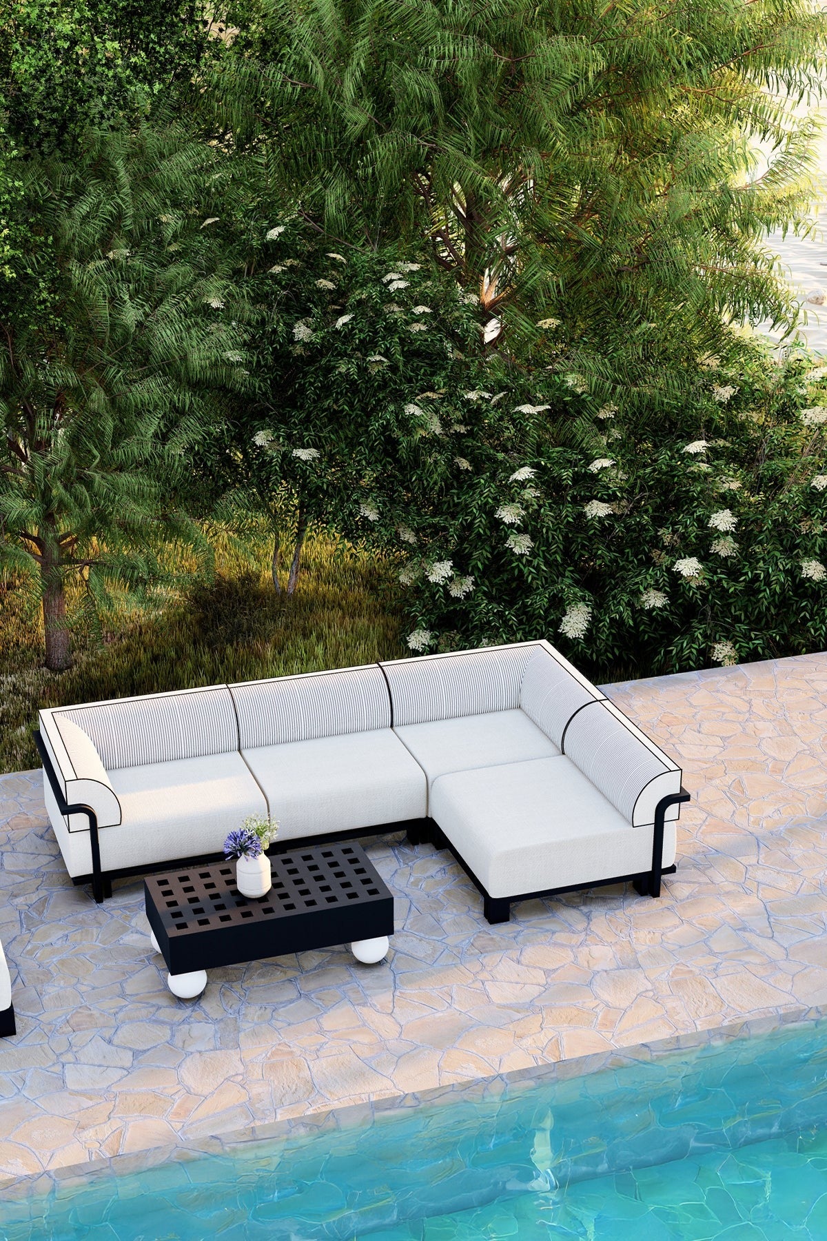 White outdoor sectional sofa with black accents by a poolside