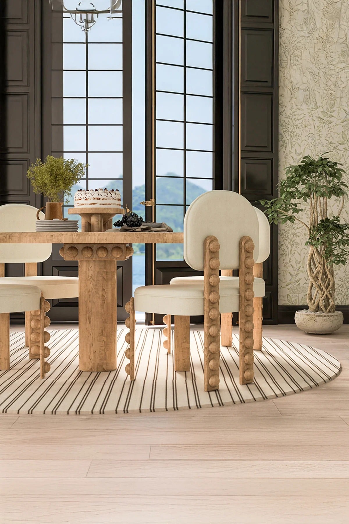 Dining room view with wood table, upholstered chairs, striped rug, large windows