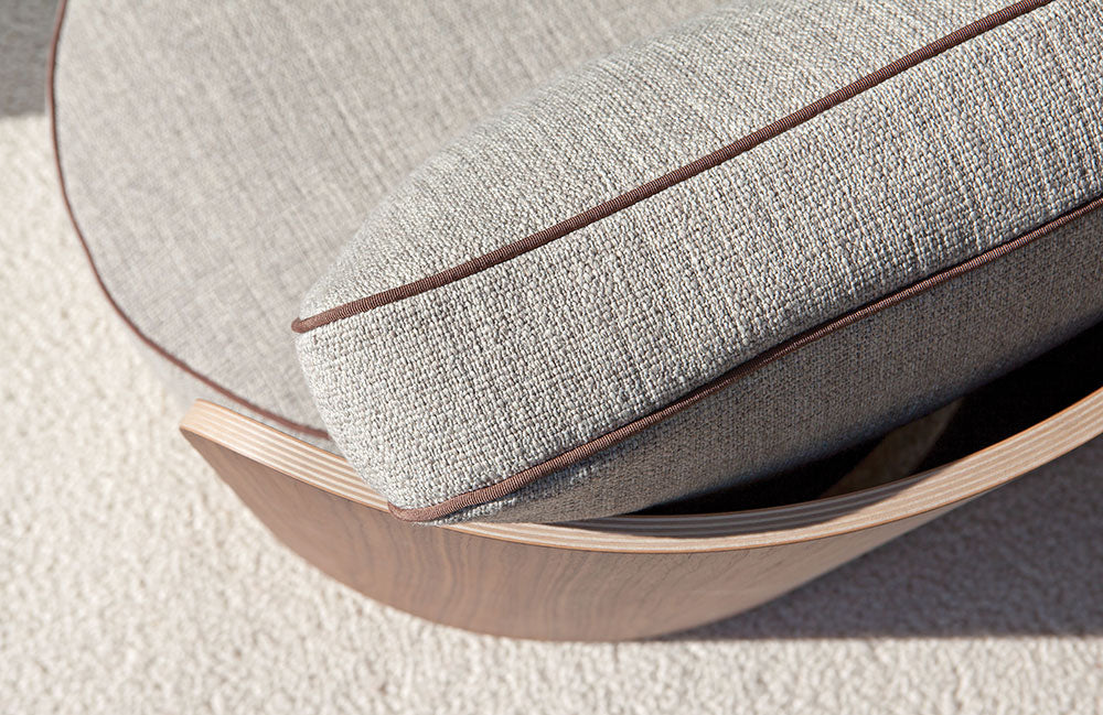 Close up view of chair cushion and curved wood base